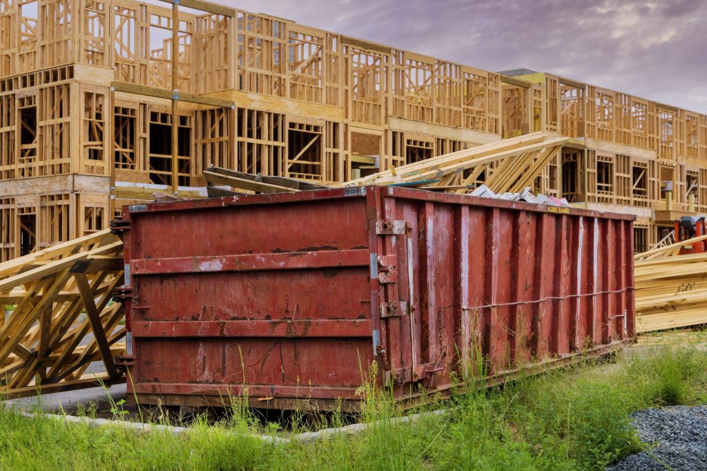 A roll off dumpster near in the construction site.